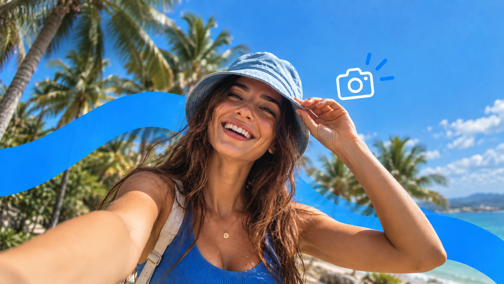 A smiling traveller in a bucket hat taking a selfie under palm trees